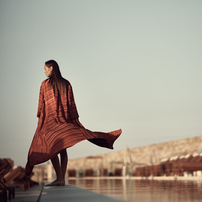 Women Standing Next to a Body of Water