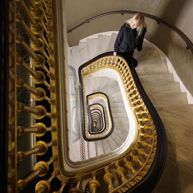 Woman walking up the stairs in lobby area