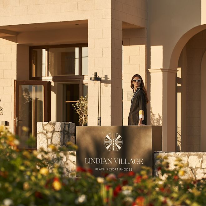 Woman Standing at the Entrance of Lindian Village Resort