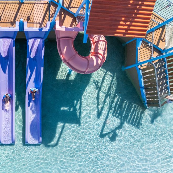 Kids on Slides in an Outdoor Swimming Pool
