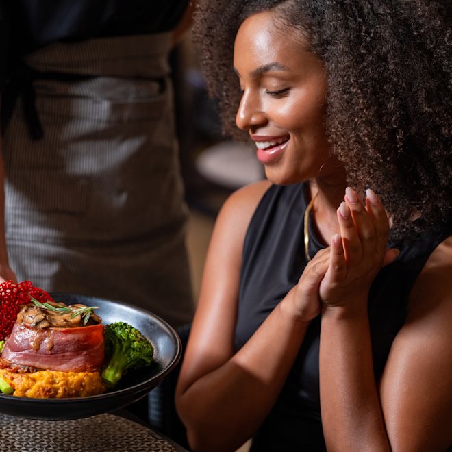 Woman Being Served Dinner at La Cava Restaurant