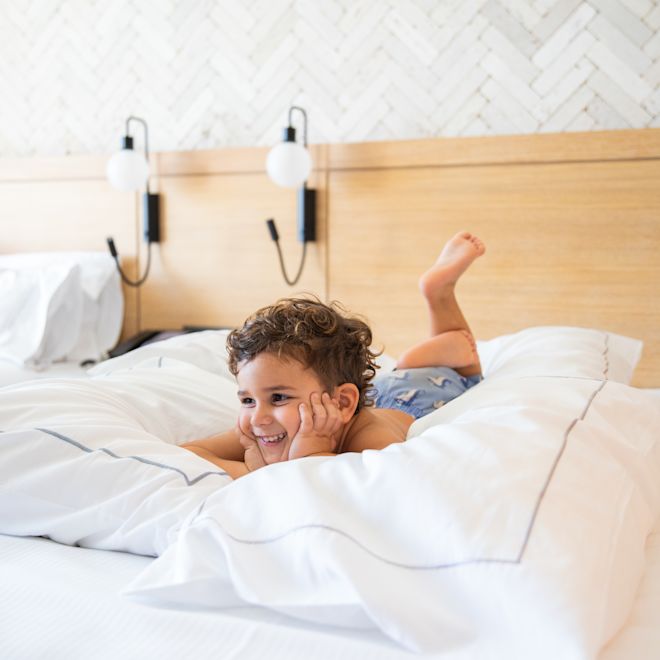 little boy lying on the bed