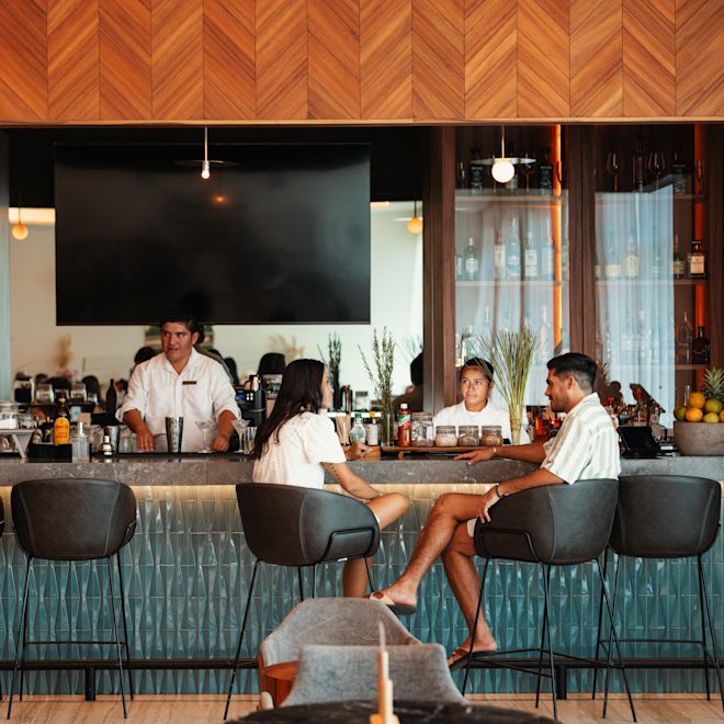 Man and woman sitting at bar area