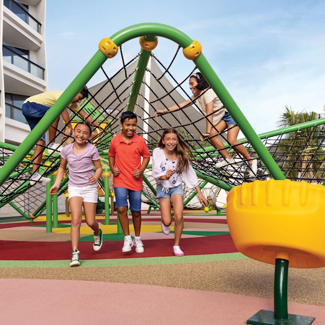 Children run through playground