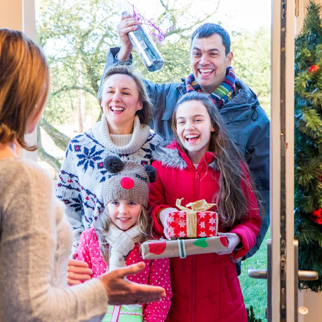 Family Delivering Christmas Presents