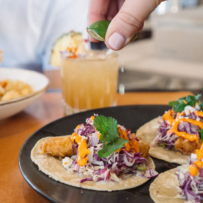 Chef squeezing lime over food