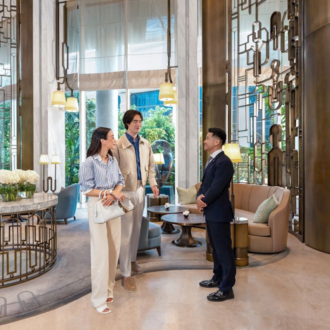 Man and woman in lobby area with staff member