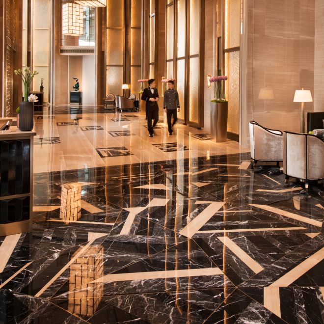 Grand arrival lobby with partial view of seating area and front desk