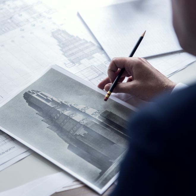 a business man looking at a picture of a building