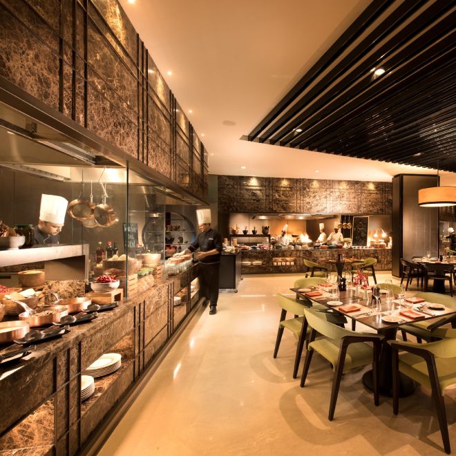 Chef at buffet with restaurant seating