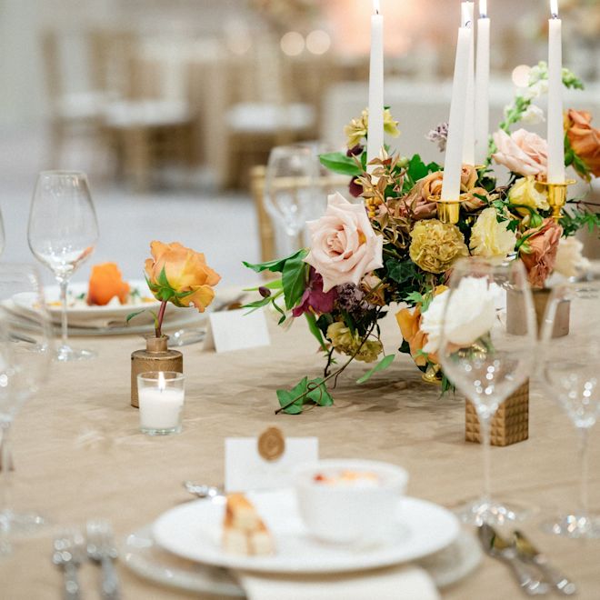 Ballroom Table Decorated with Flowers and Candles to Celebrate a Wedding