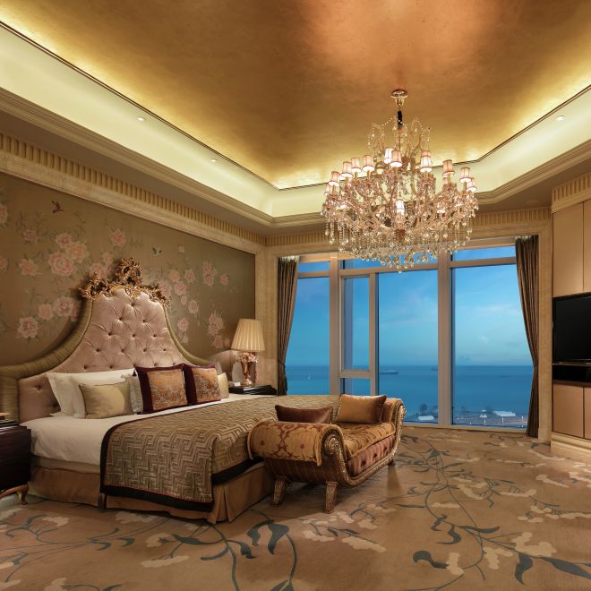 Bed in room with TV and chair