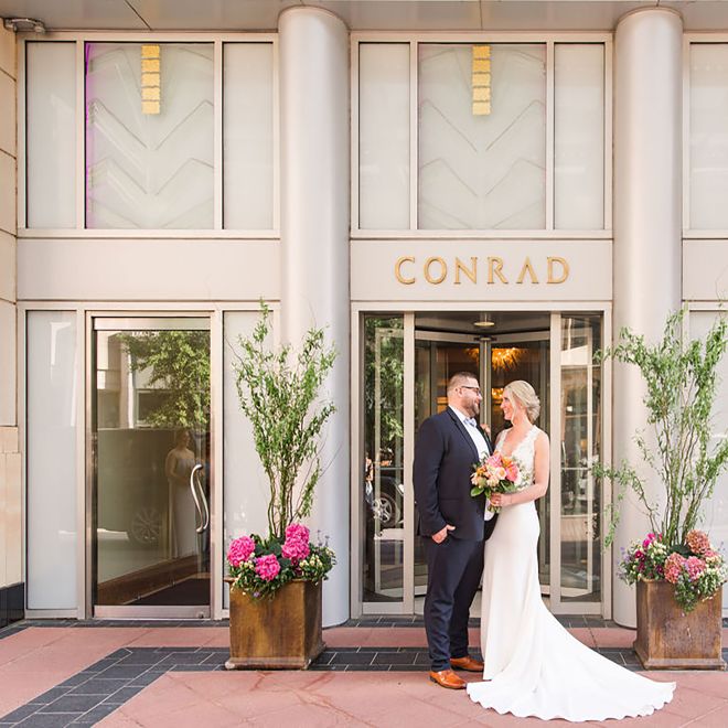 wedding couple in front of hotel