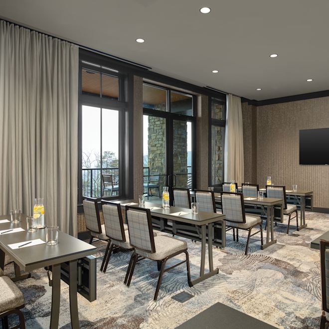 Dogwood meeting room in a classroom setup, with floor-to-ceiling windows along the side of the space.