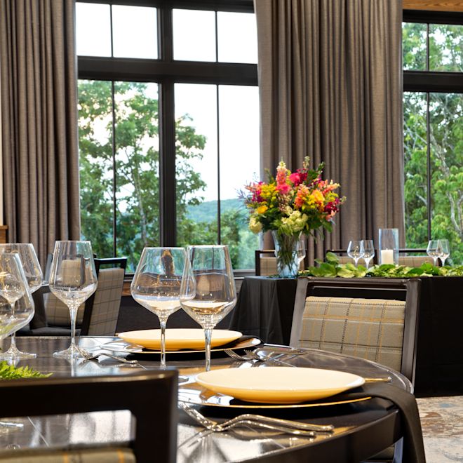 Skyline Ballroom set up for a banquet or reception head table with floor-to-ceiling windows as the backdrop.