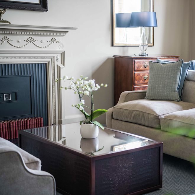 Couch in room with table and mirror
