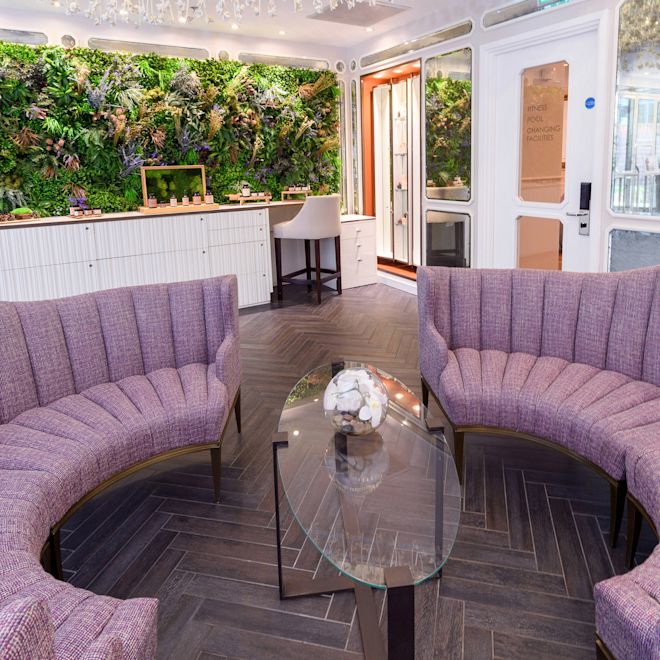 Spa Lobby with circular couches and a table with samples
