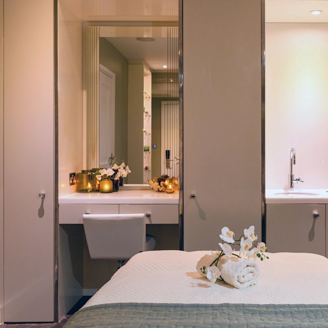 Spa treatment room with table and sink.