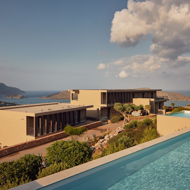 Exterior of Greco Levant with a pool overlooking the ocean and mountains.