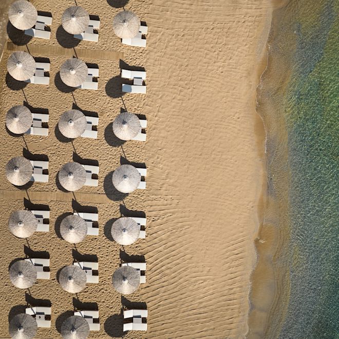 View of the Private Beach with Lounge Chairs under Umbrellas