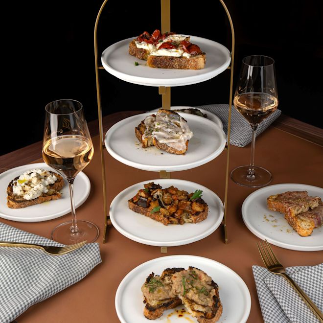 The Bronze Owl, dining table with dinner entrees and glasses of wine