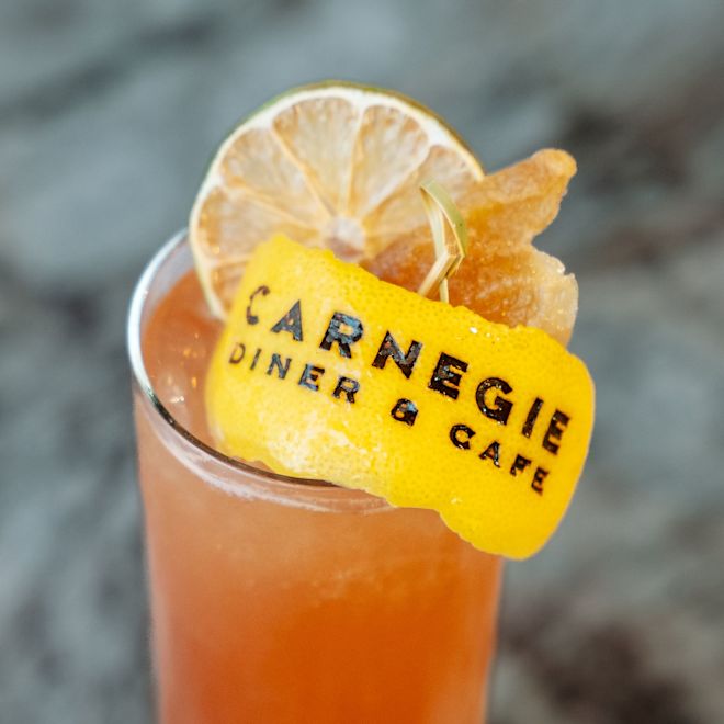 Carnegie Diner & Cafe, glass of  iced tea with a lemon peel with the text Carnegie Diner & Cafe
