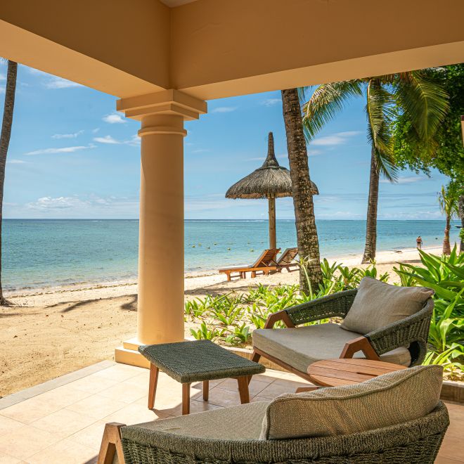 Outdoor patio with view of beach, sea and trees