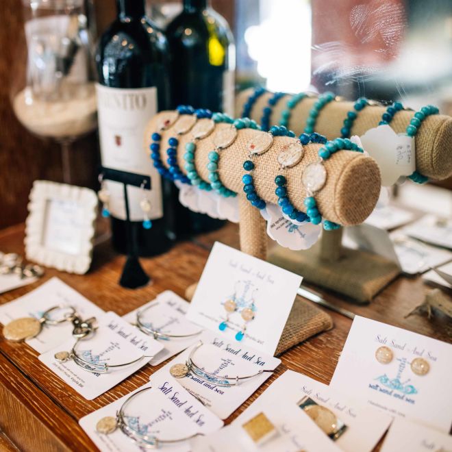 View of jewelry selection with wine bottle in background