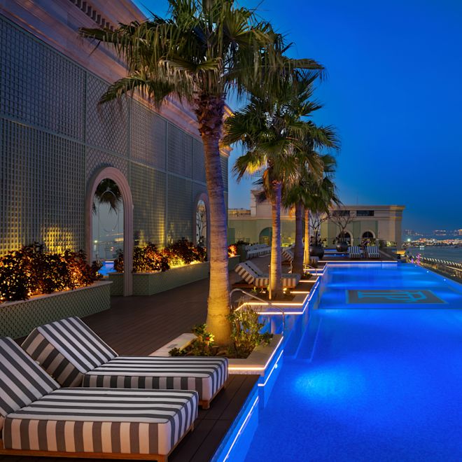 Outdoor Pool Area with View of the Beach at Night