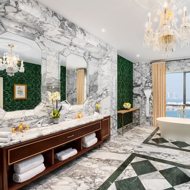 Vanity Area and Bathtub in a Suite with Sea View