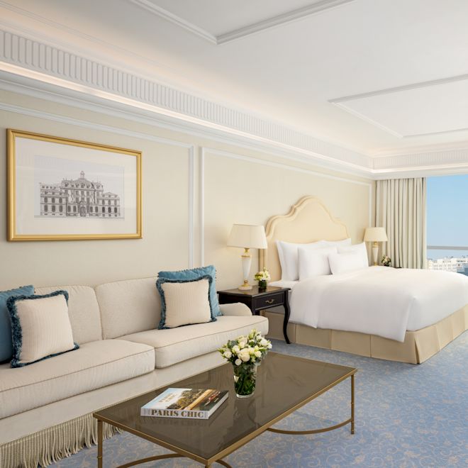 Living Area, Bed and Desk in a Junior Suite with City View