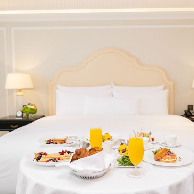 Guest room with food on bed