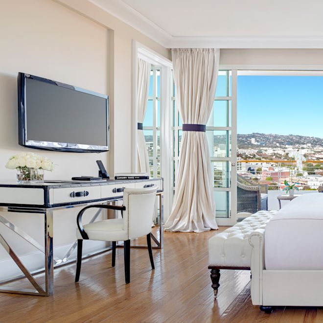 Bed in room with TV and work desk