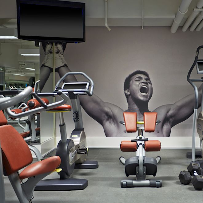 Fitness center with cardio machines, bench and TV