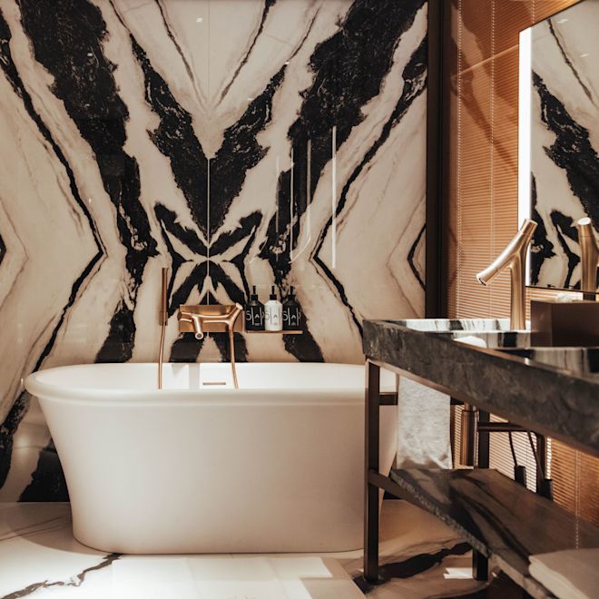 Guest room with bath tub, sink and mirror