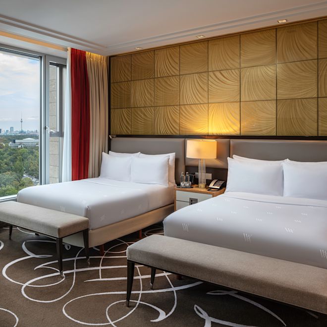 2 beds in room with lamp