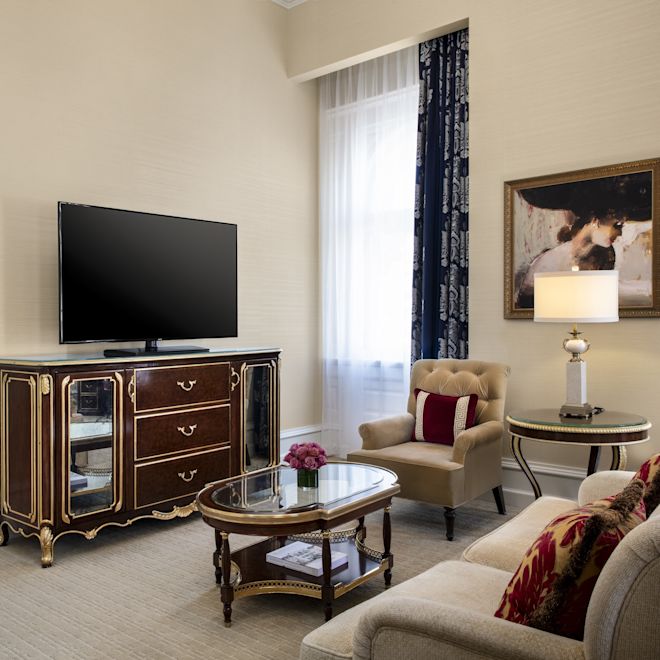 One bedroom suite lounge with TV and connecting bedroom