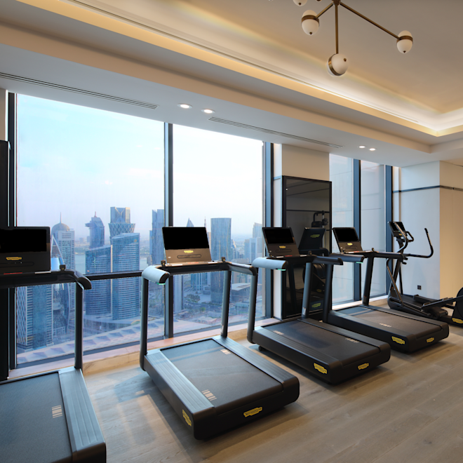 Tapis de course dans un centre sportif avec vue sur la ville depuis de grandes fenêtres
