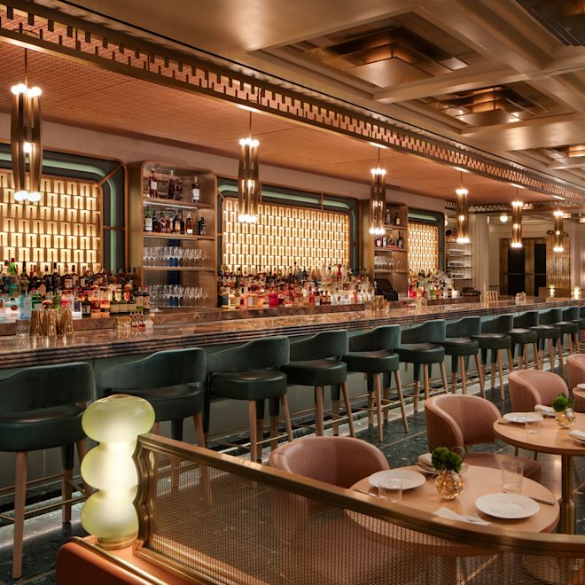 Seating area with tables and chairs alongside bar area with stools