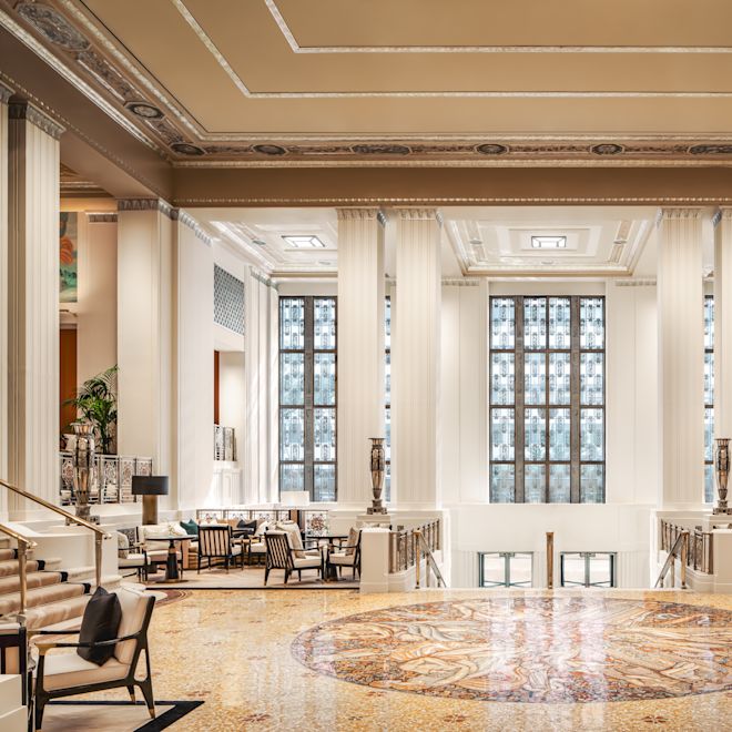 Luxurious lobby area with chairs, pillars and staircases