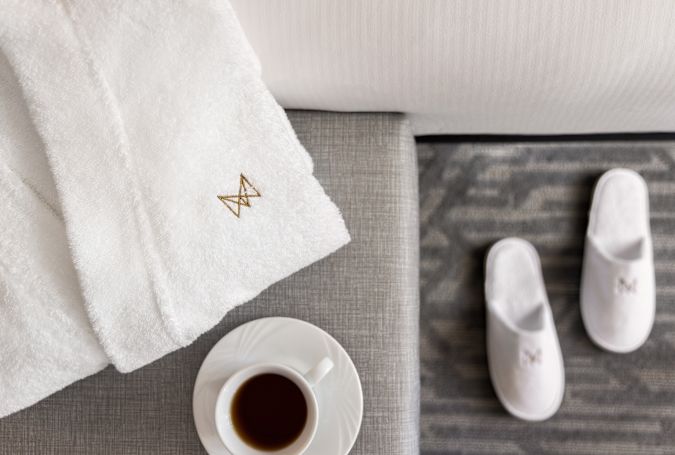 A cup of coffee and a pair of slippers.