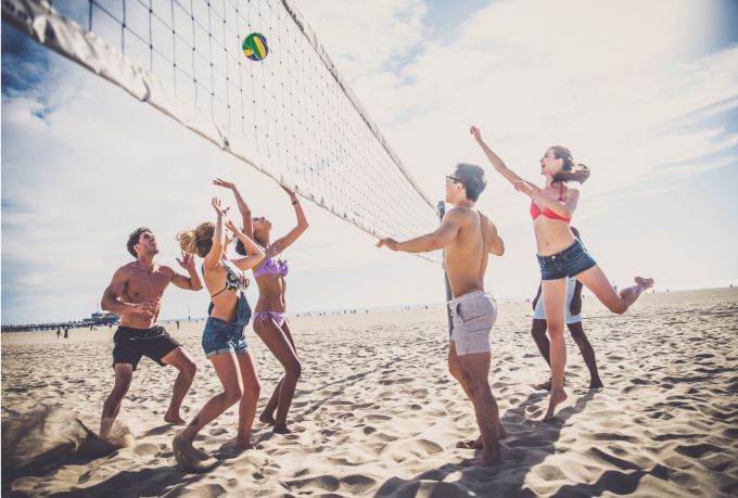 Group on beach playing volleyball