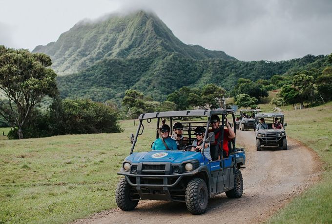 People driving in off-road vehicle on island excursion
