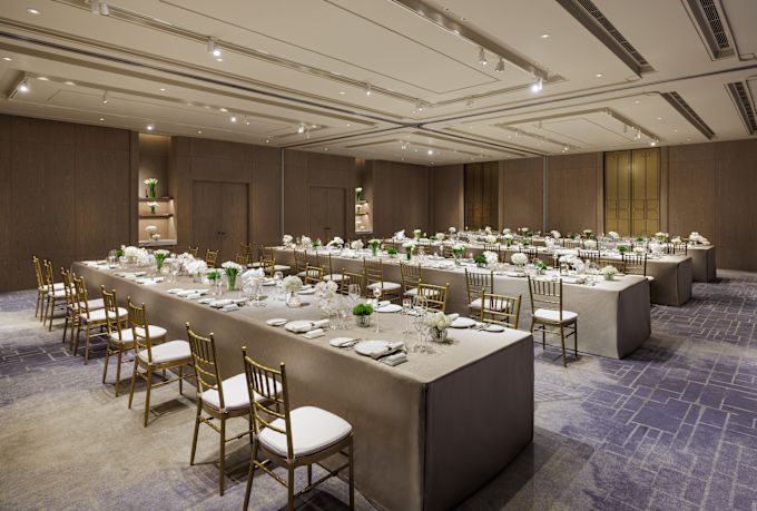 Yulania IV-VI Meeting Room Setup with Large Tables Decorated with Flowers for an Event