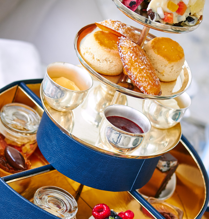 Afternoon tea cake stand with scones, madeleines jams and cream