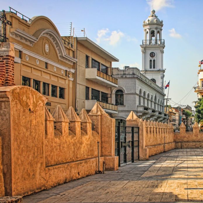 Historic City Center Plaza with skyline of Colonial buildings and church in Santo Domingo, Dominican Republic.