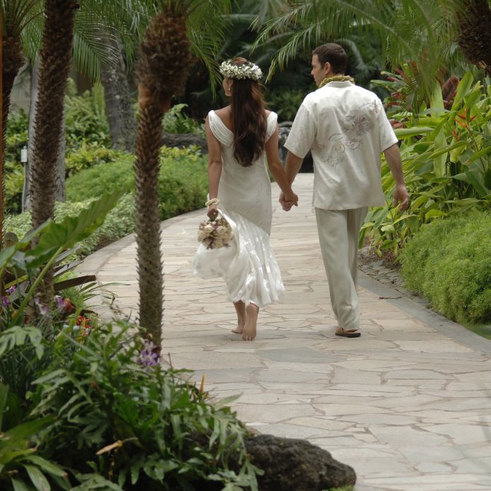 Couple Walking in a Garden Holding Hands