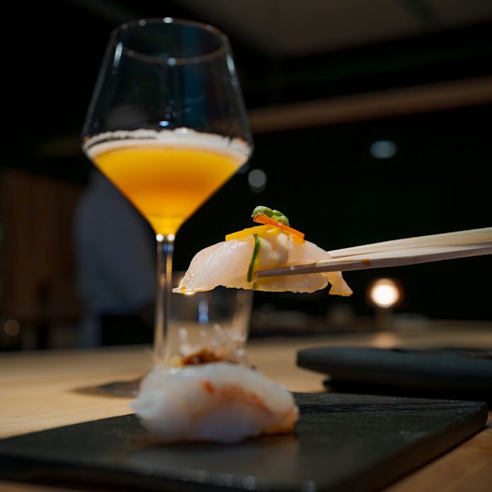 Moody Tongue Sushi and a Drink on a Table