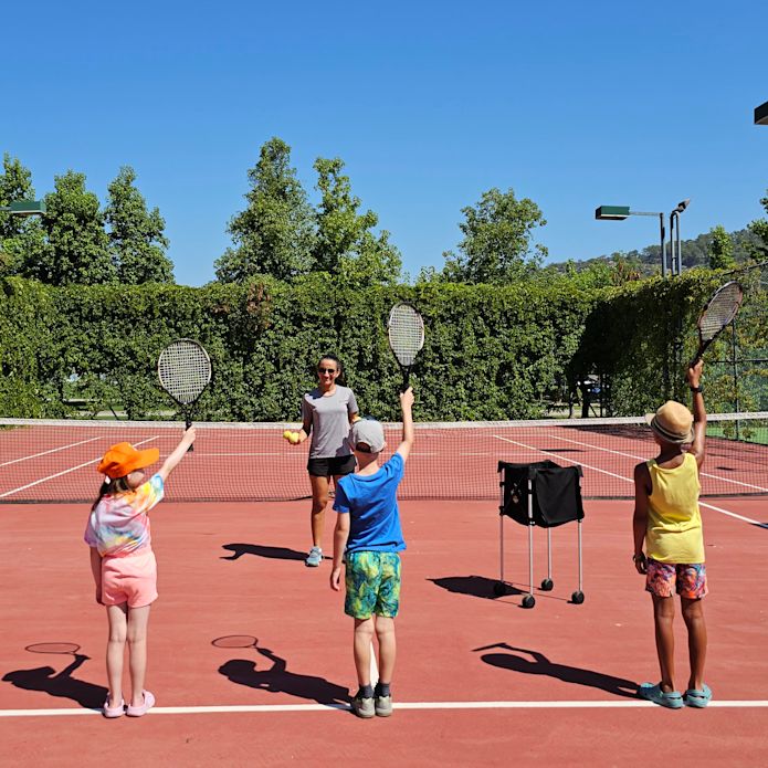 Kids Playing Tennis on a Sports Court