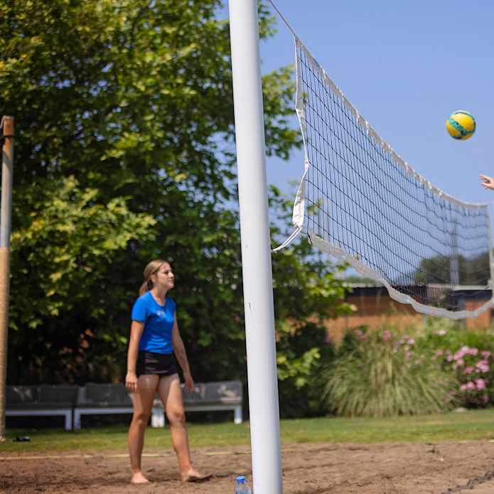 Teenagers Playing Volleyball Outdoors